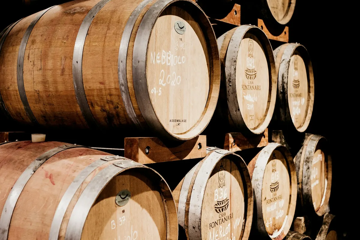 Oak barrels stacked on racks in a cellar