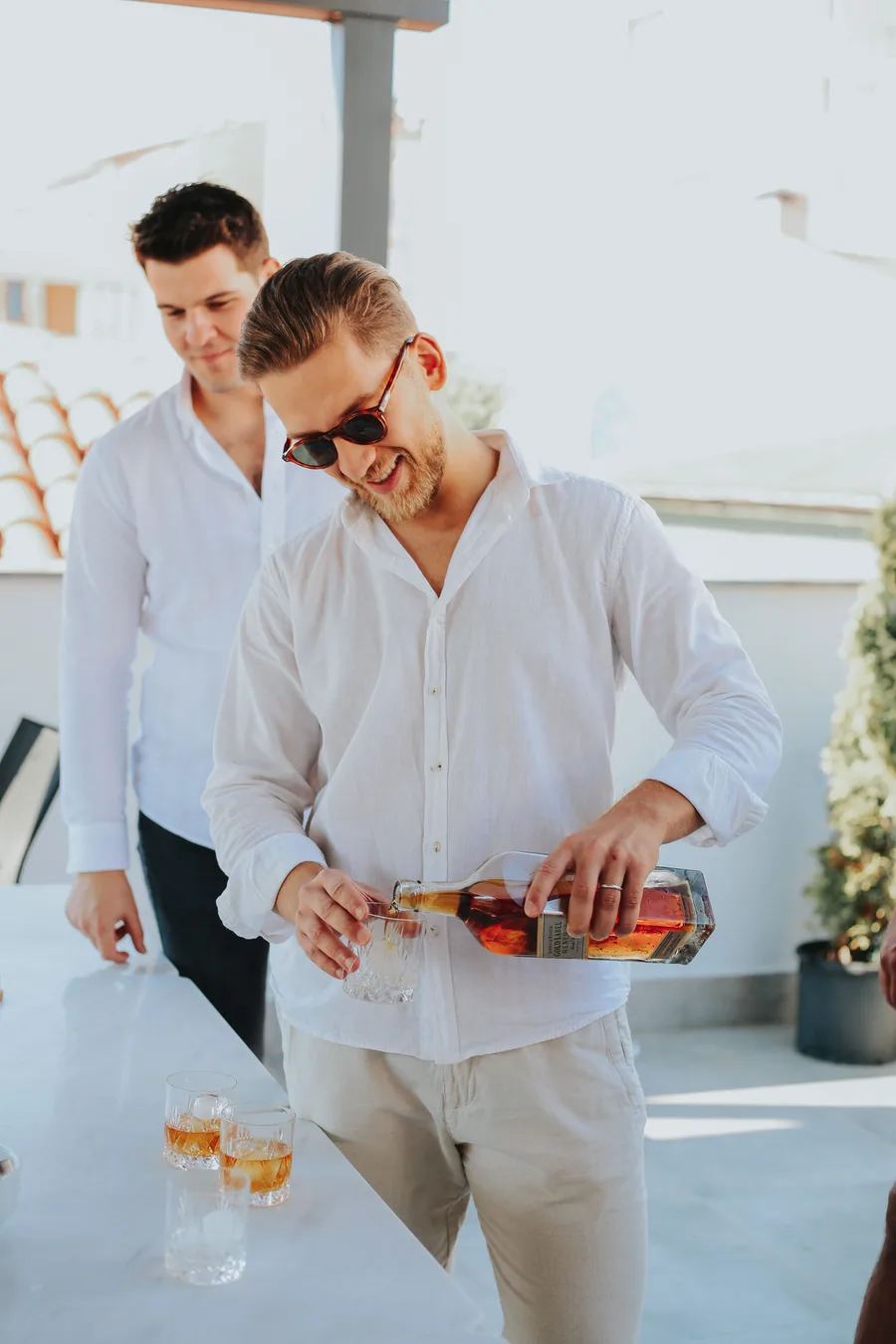 Friends sharing a pour on a rooftop