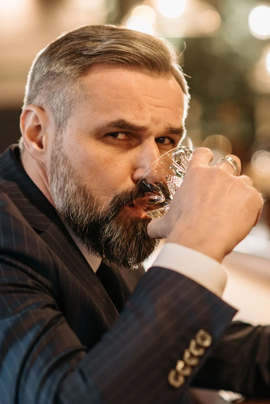 A collector nosing a dram of Scotch whisky
