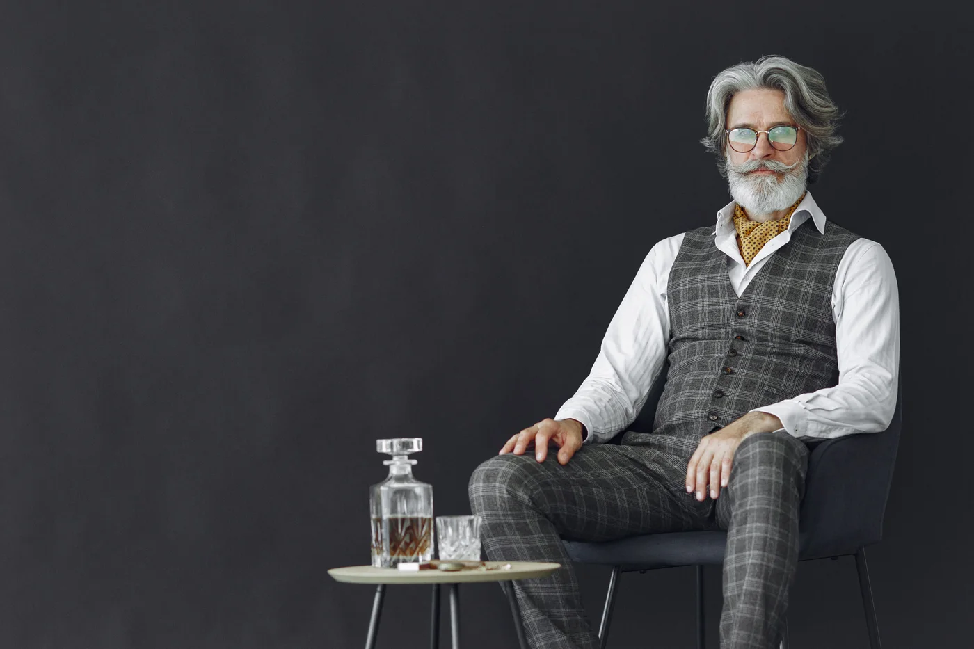 A whisky collector relaxes beside a crystal decanter