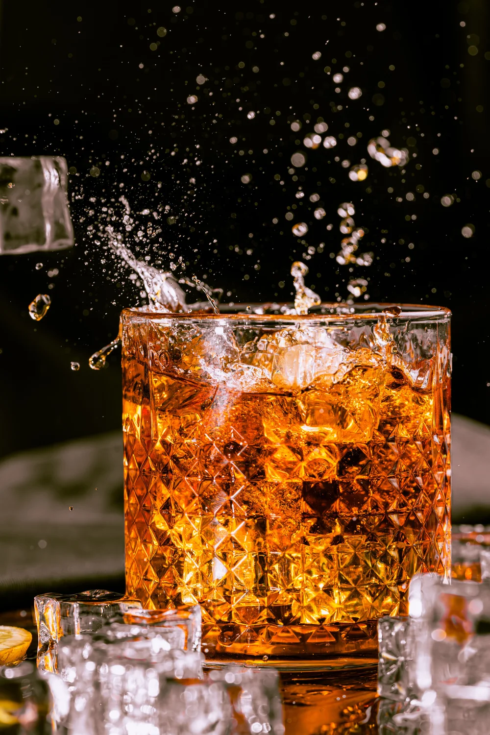 Whisky poured over ice, caught mid-splash